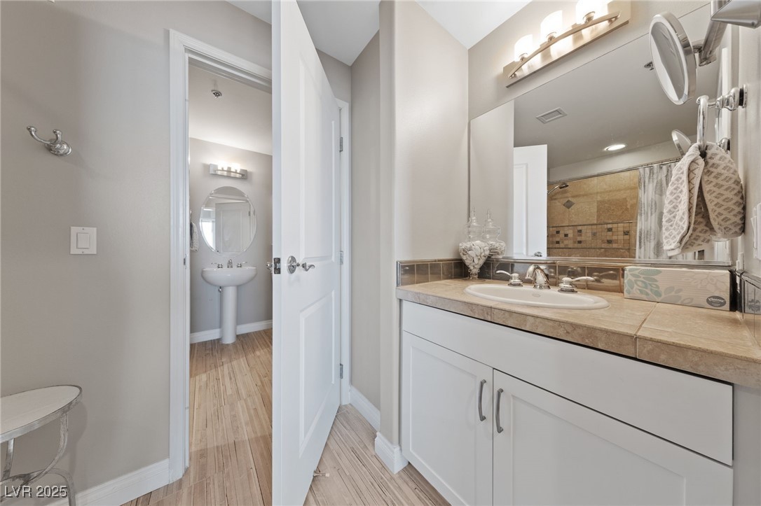 8255 South Las Vegas Boulevard, Unit 809 Las Vegas, NV 89123 - Photo 13 of 32 Full bathroom with tiled shower and wood finished