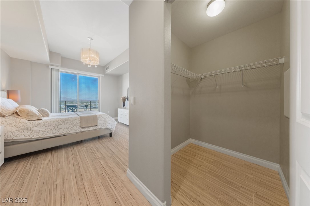 8255 South Las Vegas Boulevard, Unit 809 Las Vegas, NV 89123 - Photo 15 of 32 Bedroom featuring wood finished floors and a chand