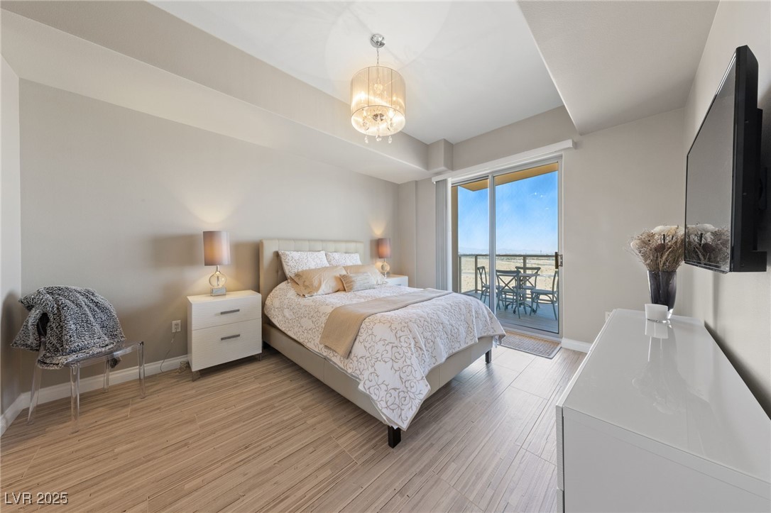 8255 South Las Vegas Boulevard, Unit 809 Las Vegas, NV 89123 - Photo 16 of 32 Bedroom with access to exterior, light wood-style