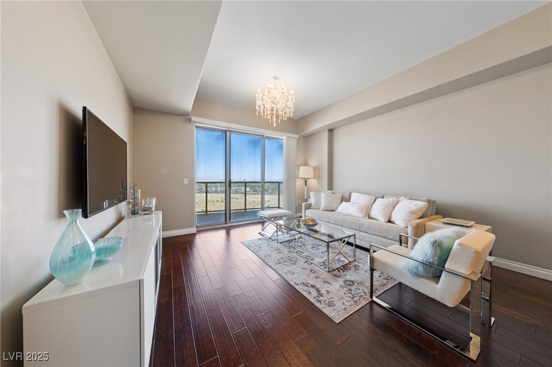 8255 South Las Vegas Boulevard, Unit 809 Las Vegas, NV 89123 - Photo 4 of 32 Living room with a chandelier and dark wood-type f