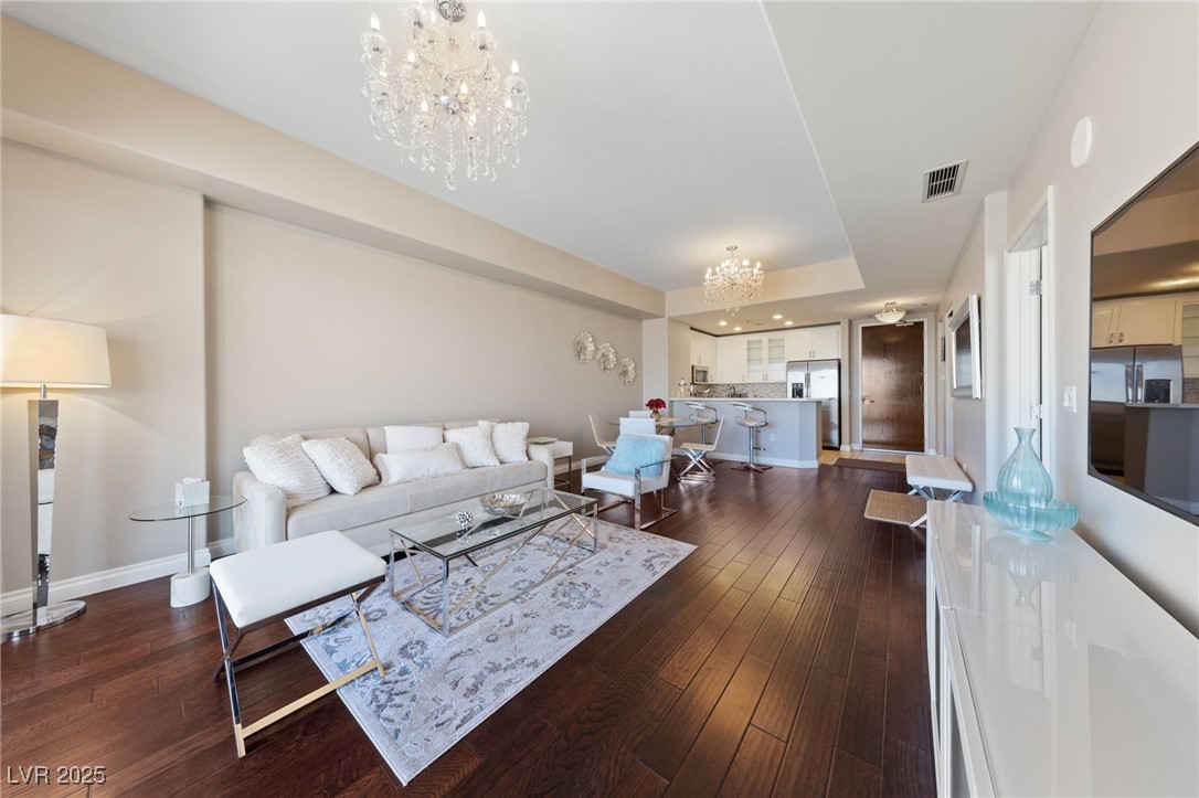 8255 South Las Vegas Boulevard, Unit 809 Las Vegas, NV 89123 - Photo 5 of 32 Living area featuring a chandelier and dark wood f