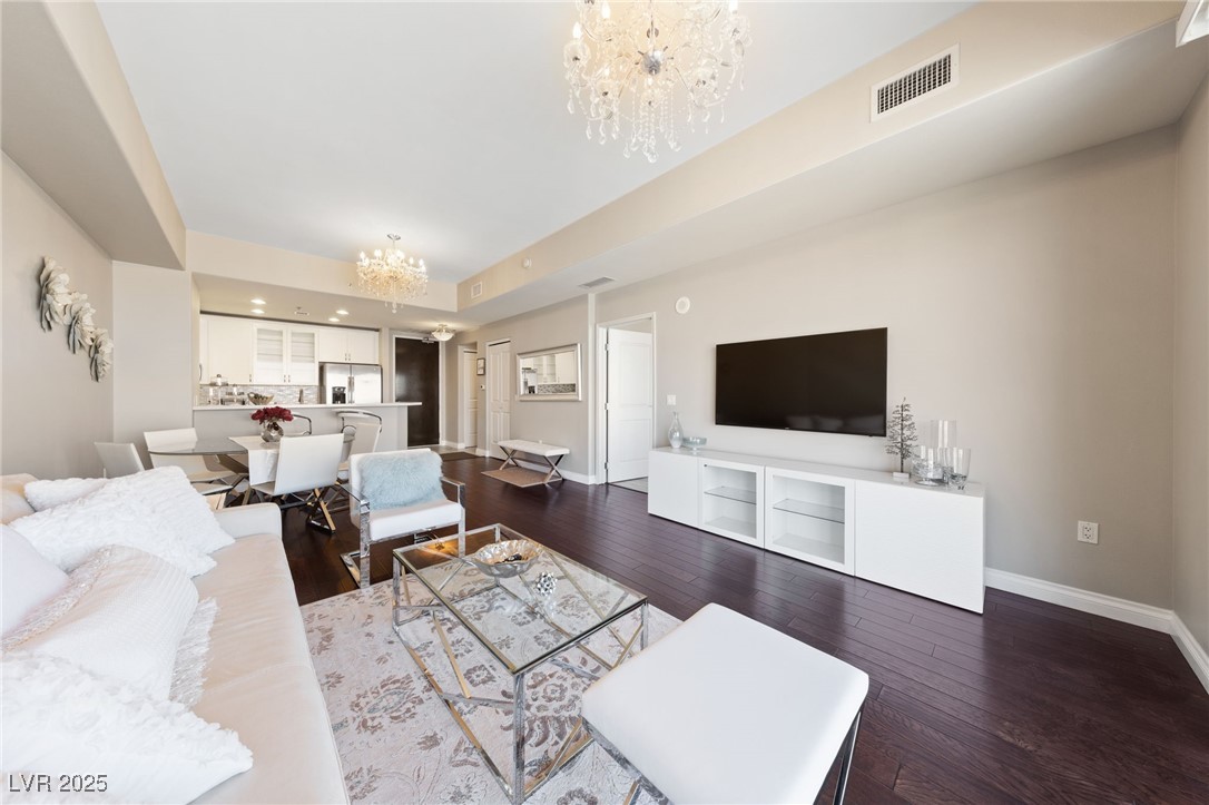 8255 South Las Vegas Boulevard, Unit 809 Las Vegas, NV 89123 - Photo 6 of 32 Living room with a chandelier and dark wood-style