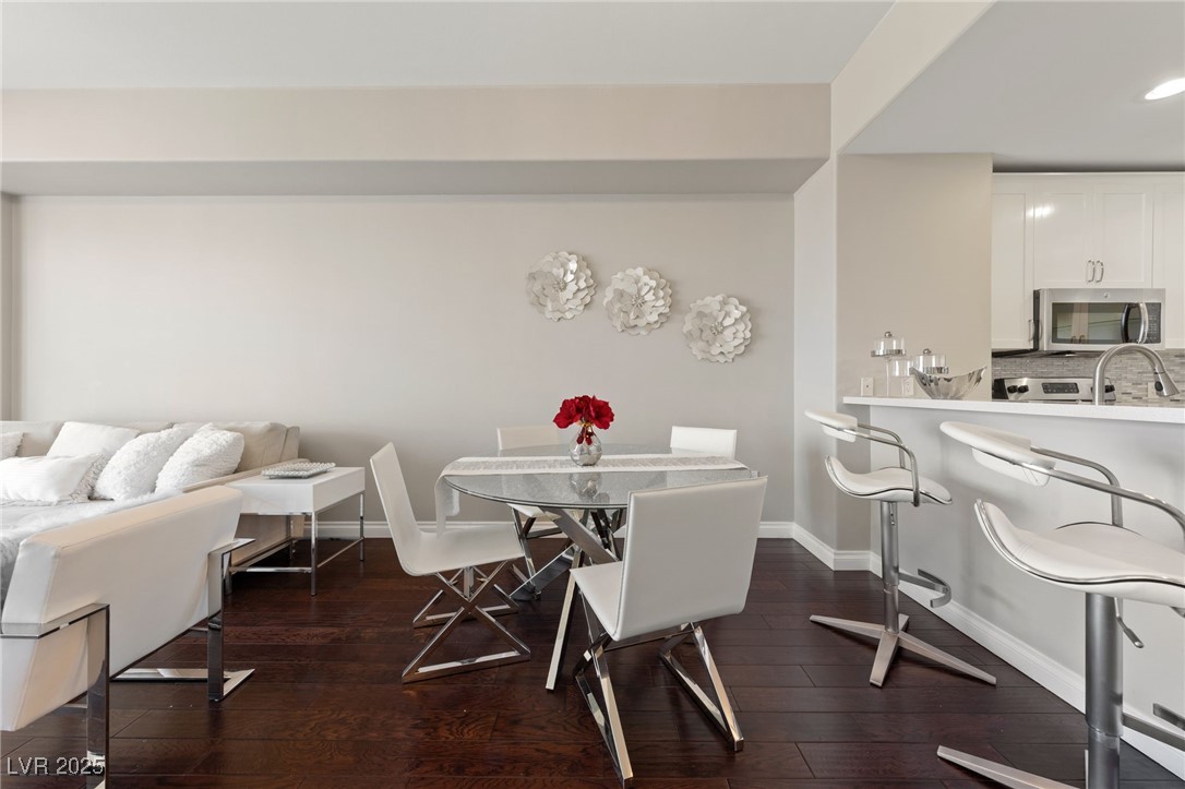 8255 South Las Vegas Boulevard, Unit 809 Las Vegas, NV 89123 - Photo 7 of 32 Dining area with dark wood-style floors and basebo