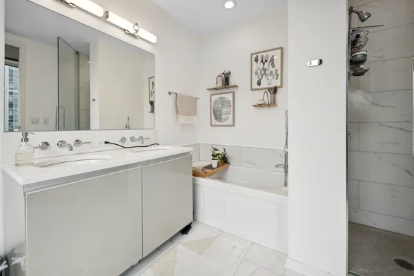 a large bed sitting in a bedroom next to a window