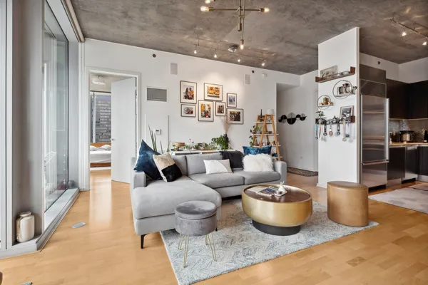 a living room with lots of furniture and a chandelier
