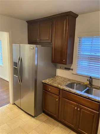 a kitchen with stainless steel appliances granite countertop a refrigerator and a sink