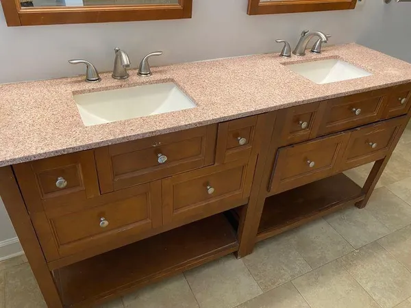 a bathroom with a granite countertop sink and a mirror
