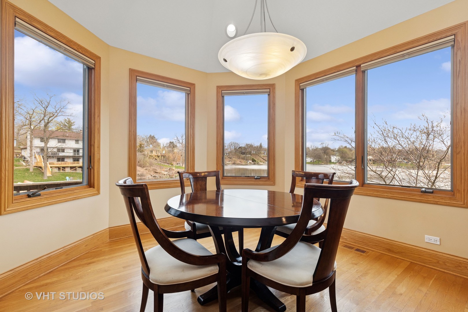 6107 Lake Shore Drive Cary, IL 60013 - Photo 15 of 40 a view of a dining room with furniture large windows and wooden floor