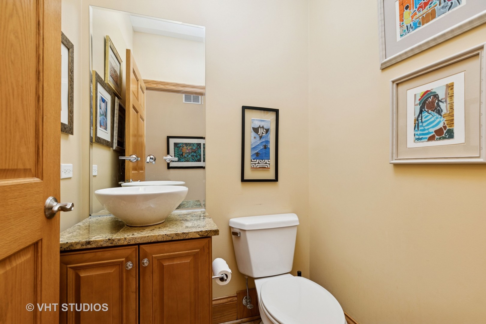 6107 Lake Shore Drive Cary, IL 60013 - Photo 21 of 40 a bathroom with a granite countertop toilet and a sink