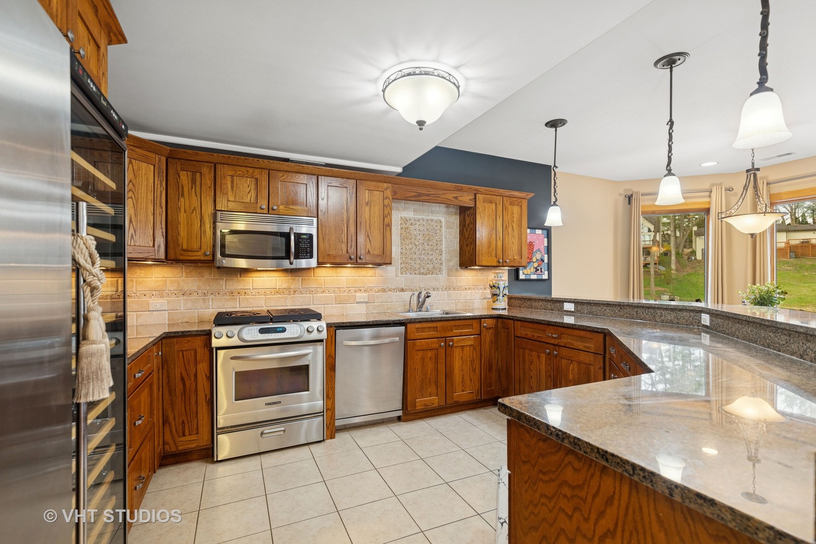 6107 Lake Shore Drive Cary, IL 60013 - Photo 32 of 40 a kitchen with stainless steel appliances granite countertop a sink a stove and a wooden floors