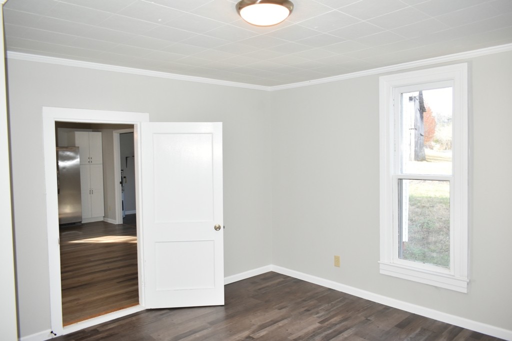 5 Dog Branch Road Pleasant Shade, TN 37145 - Photo 4 of 8 a view of an empty room with wooden floor and a window