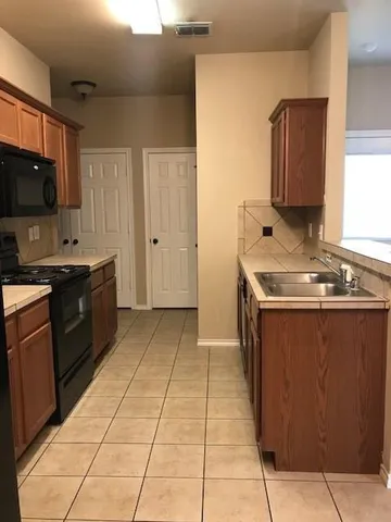 a kitchen with a sink counter top space and cabinets