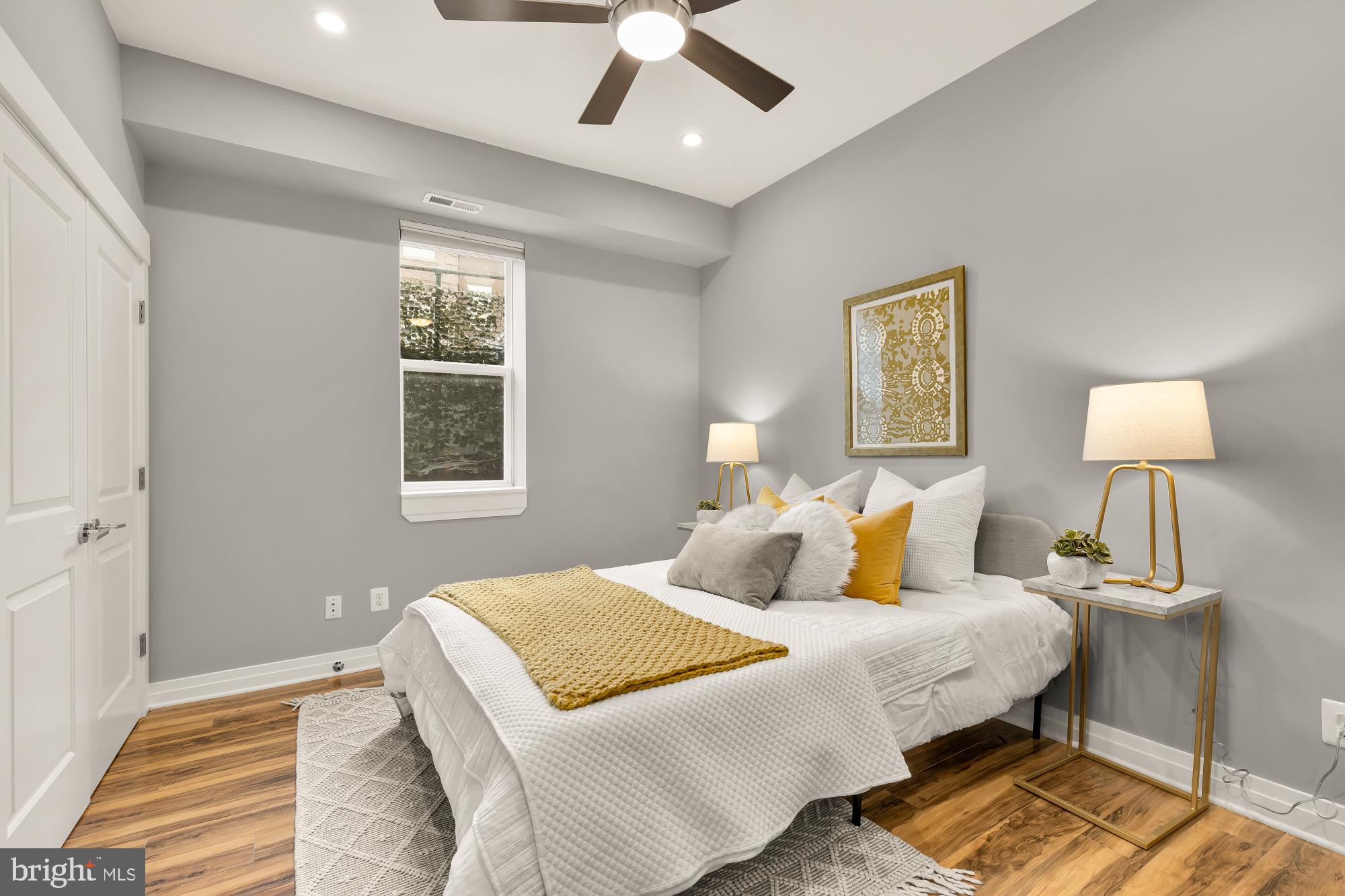 1719 Lincoln Road Northeast, Unit 1 Washington, DC 20002 - Photo 13 of 23 a bedroom with a bed and a lamp on dresser