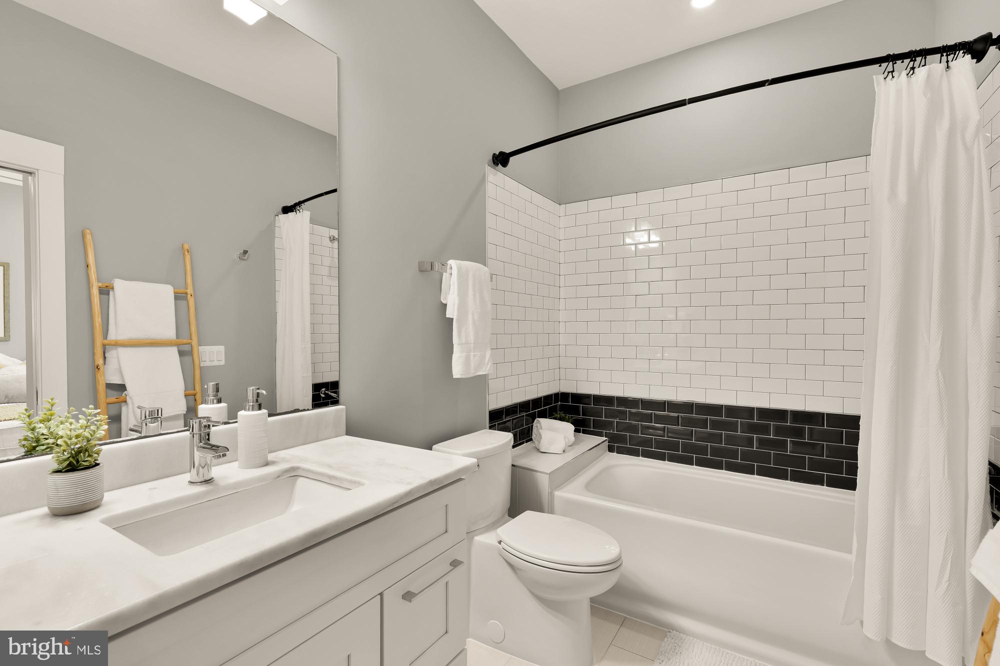 1719 Lincoln Road Northeast, Unit 1 Washington, DC 20002 - Photo 15 of 23 a bathroom with a sink a toilet and a bathtub