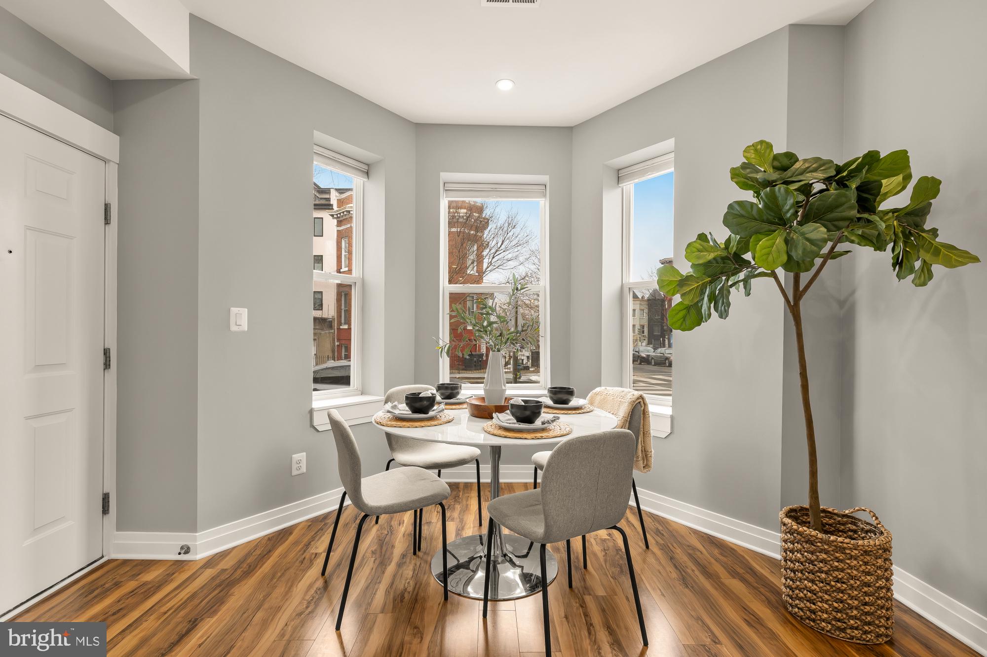 1719 Lincoln Road Northeast, Unit 1 Washington, DC 20002 - Photo 4 of 23 a dining room with furniture potted plants and wooden floor