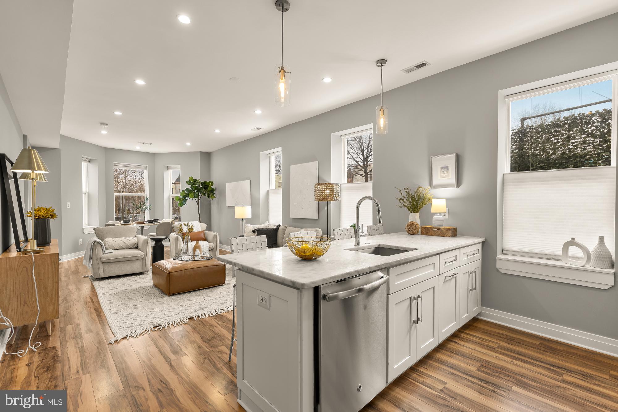 1719 Lincoln Road Northeast, Unit 1 Washington, DC 20002 - Photo 8 of 23 a kitchen with stainless steel appliances granite countertop a sink and living room view