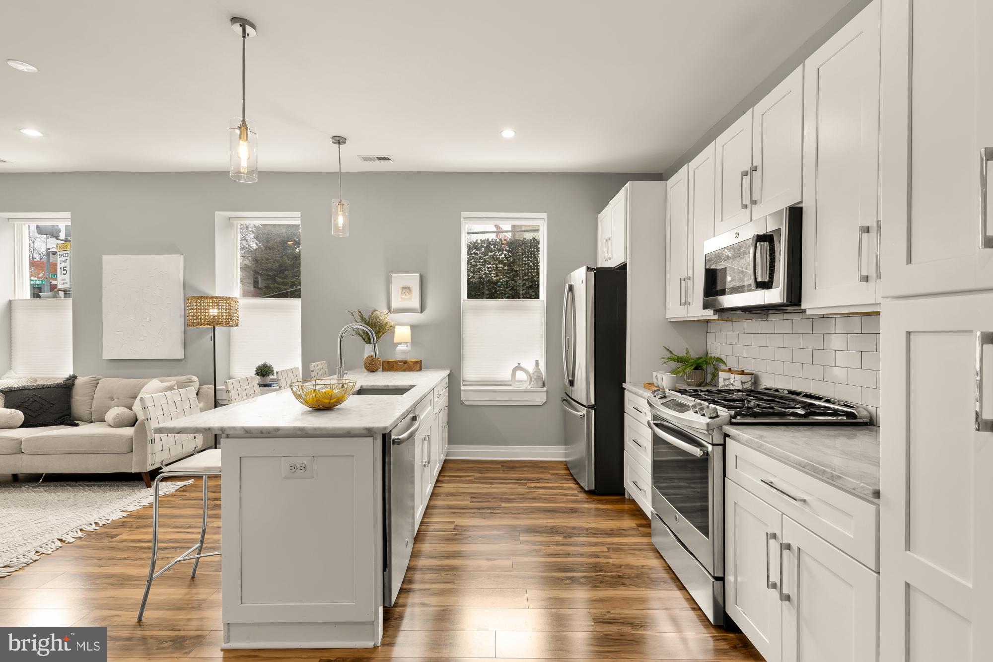 1719 Lincoln Road Northeast, Unit 1 Washington, DC 20002 - Photo 10 of 23 a kitchen with stainless steel appliances kitchen island granite countertop a sink stove and refrigerator