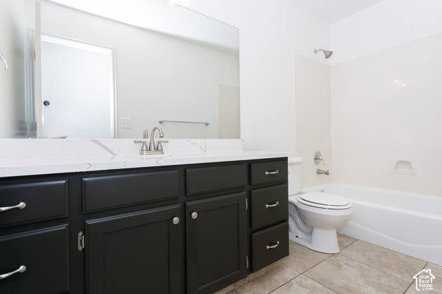 1742 Renaissance Way Springville, UT 84663 - Photo 12 of 23 Dark wood vanity with brushed nickel hardware, white countertop, tile flooring, and a white bathtub with shower