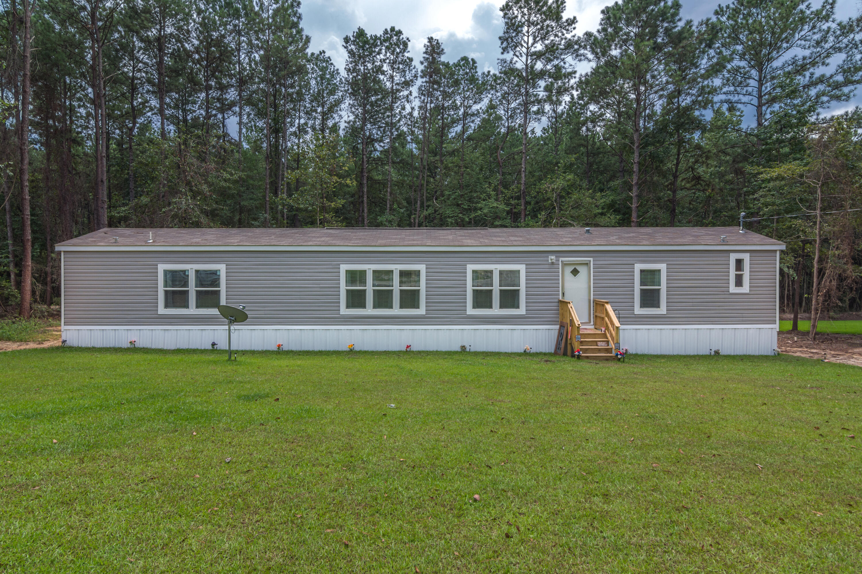 3934 Chambray Road Crestview, FL 32539 - Photo 1 of 24 a front view of a house with a garden