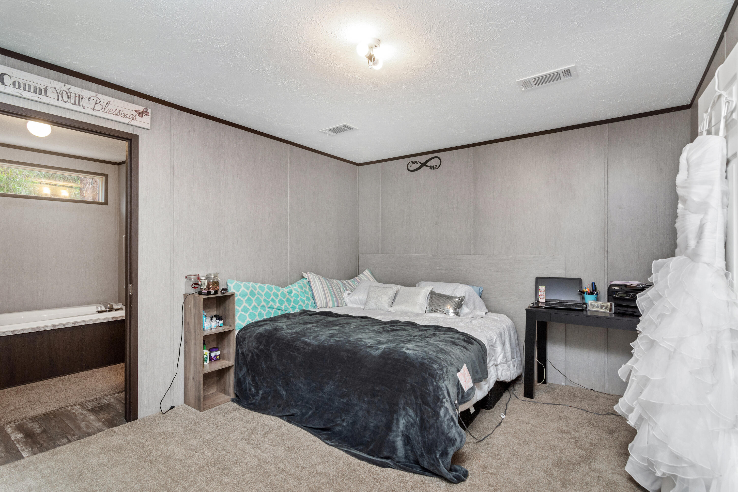 3934 Chambray Road Crestview, FL 32539 - Photo 13 of 24 a bedroom with a bed and a lamp