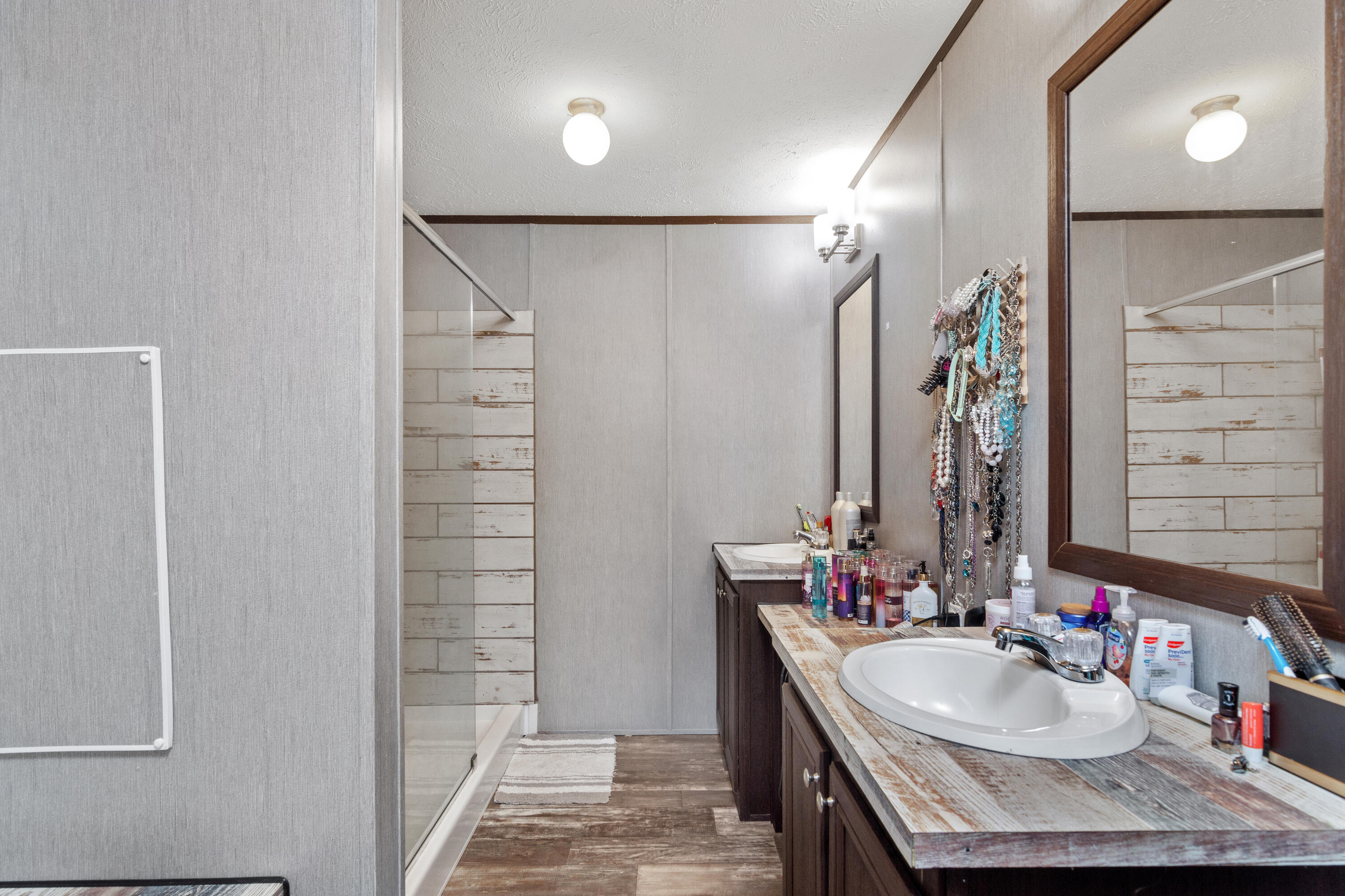 3934 Chambray Road Crestview, FL 32539 - Photo 15 of 24 a bathroom with a granite countertop sink a mirror and shower