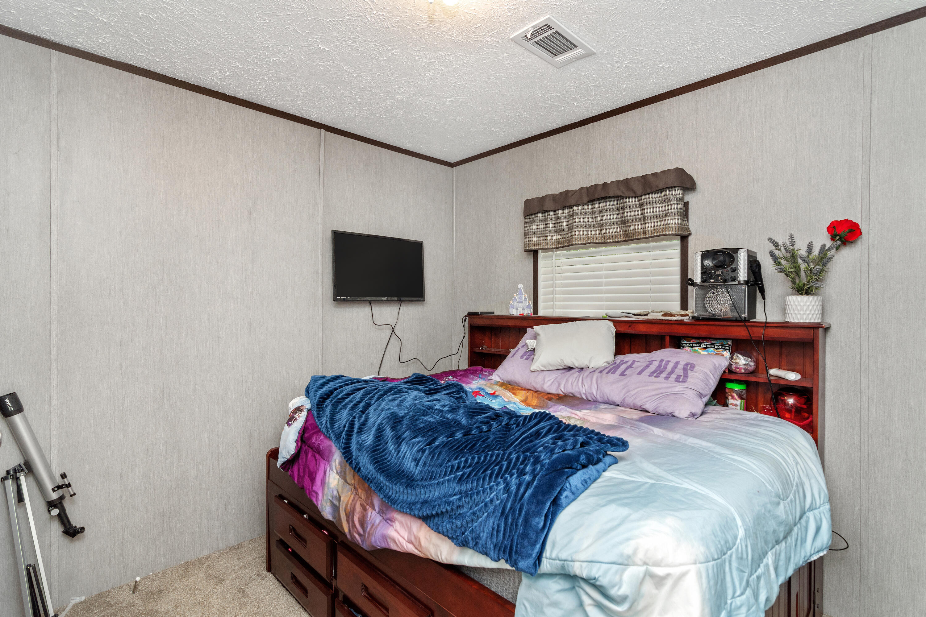 3934 Chambray Road Crestview, FL 32539 - Photo 19 of 24 a bedroom with a bed and a flat screen tv