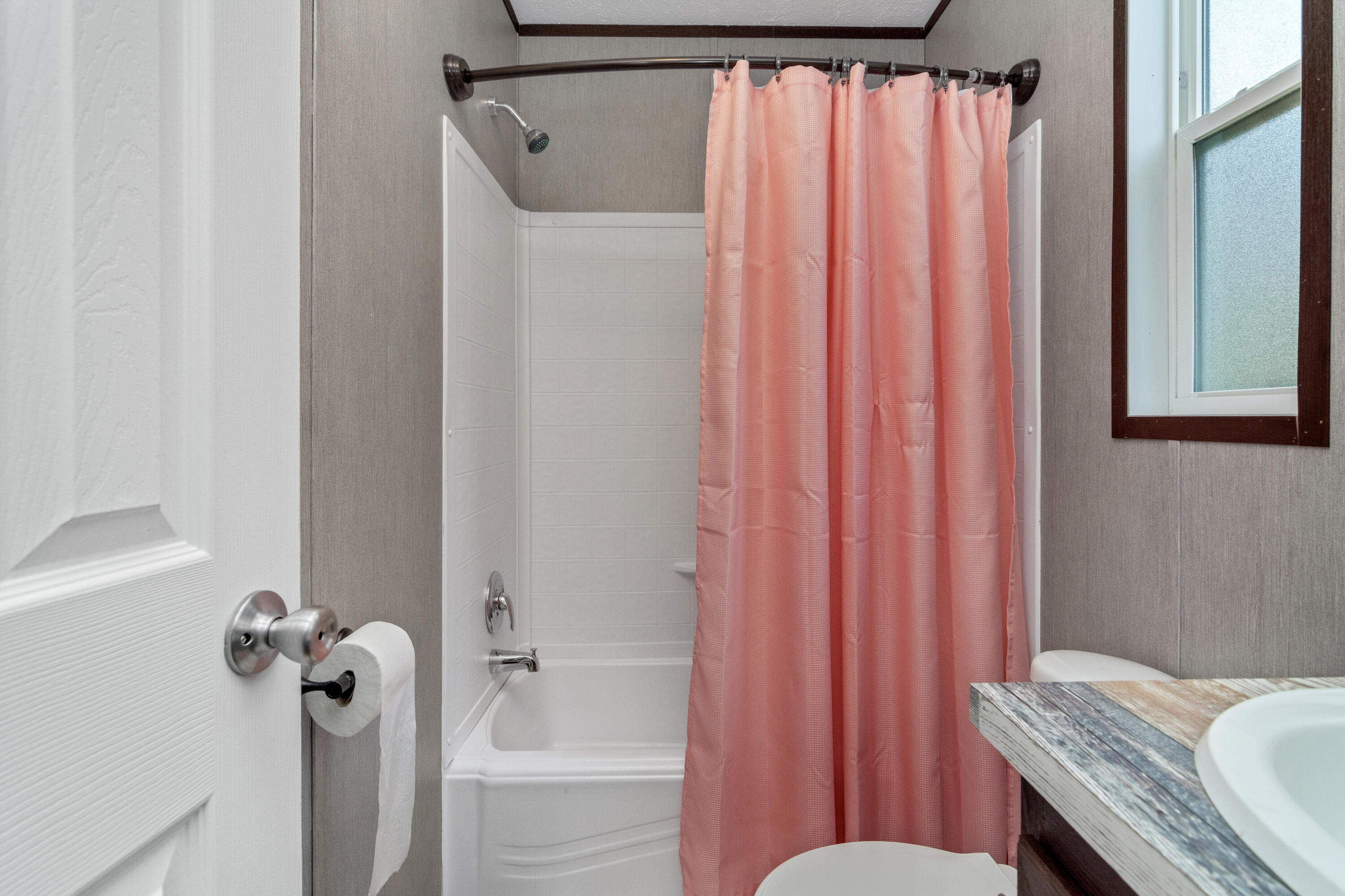 3934 Chambray Road Crestview, FL 32539 - Photo 20 of 24 a bathroom with a shower curtain and a window