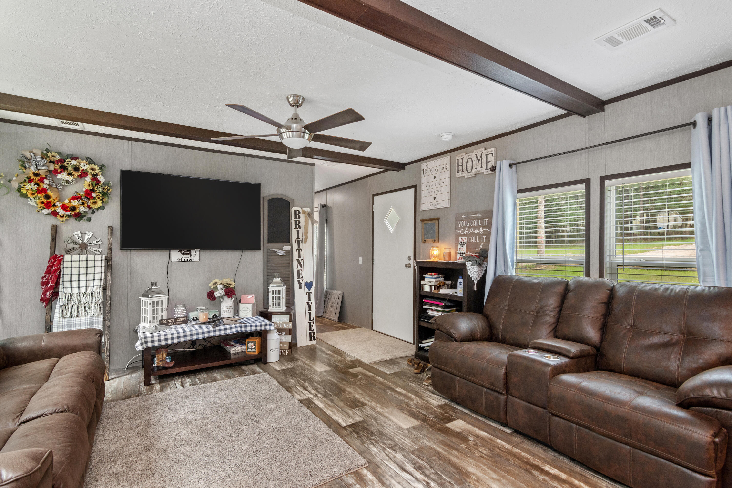 3934 Chambray Road Crestview, FL 32539 - Photo 5 of 24 a living room with furniture a flat screen tv and a chandelier