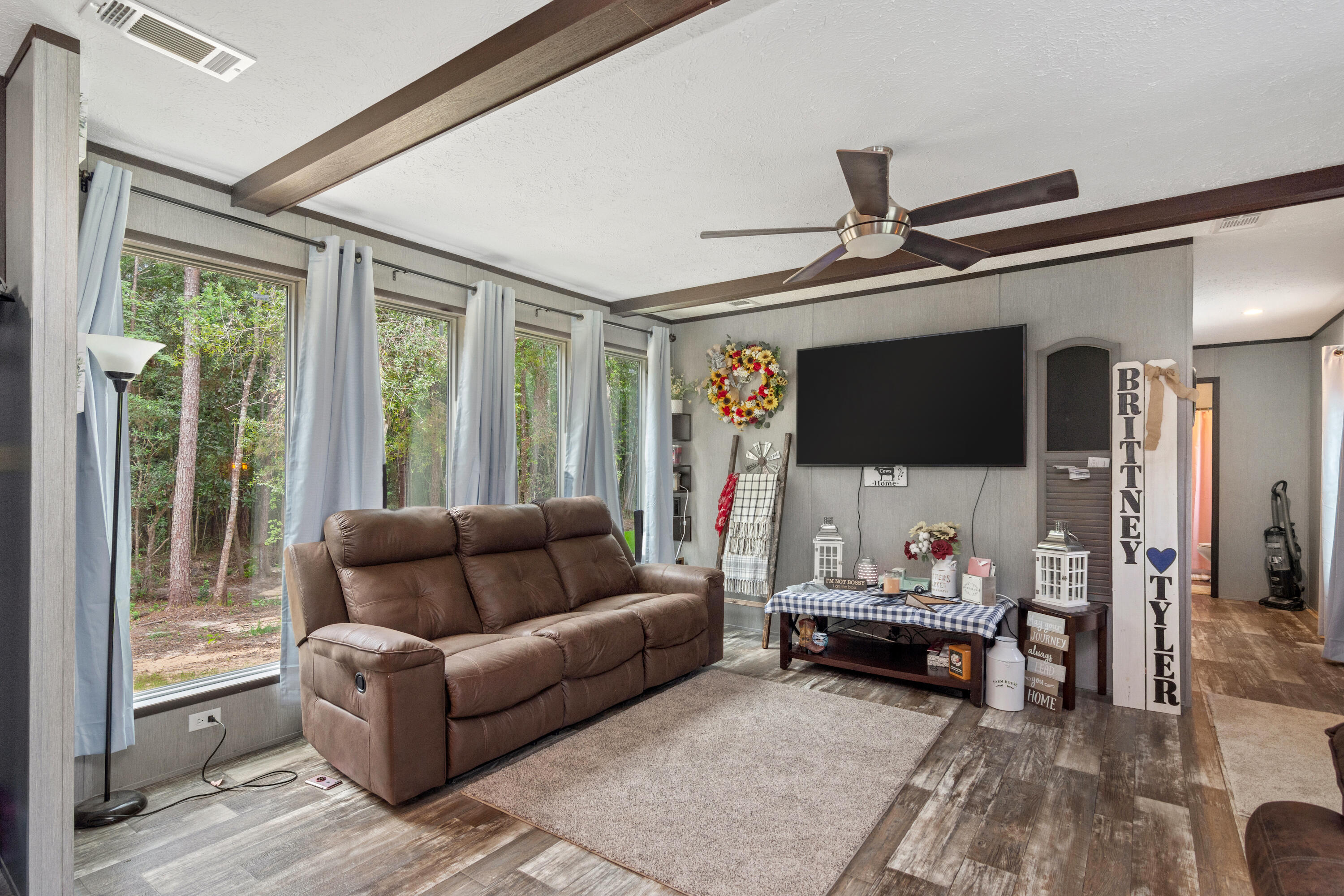 3934 Chambray Road Crestview, FL 32539 - Photo 6 of 24 a living room with furniture and a flat screen tv