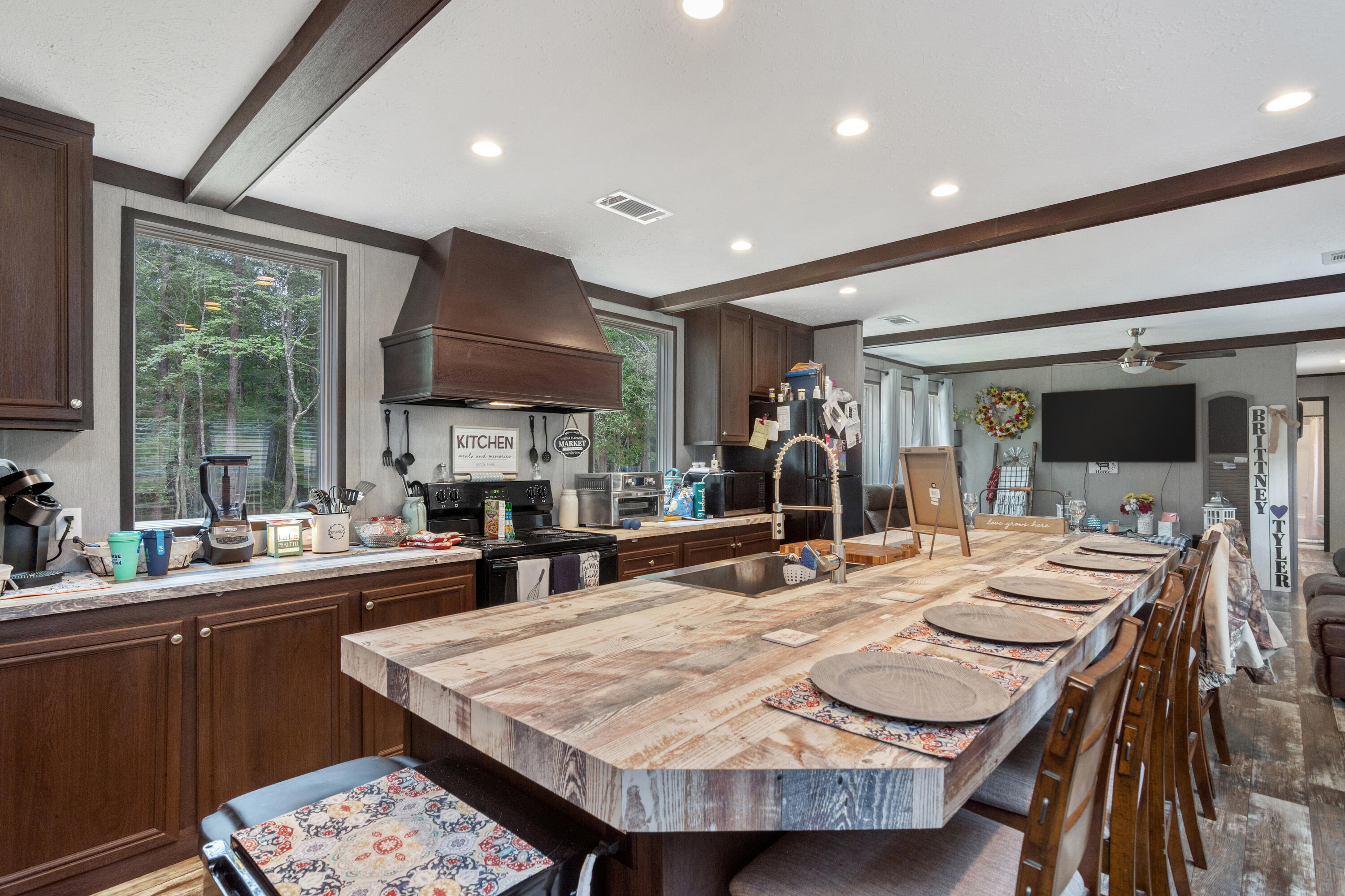 3934 Chambray Road Crestview, FL 32539 - Photo 10 of 24 a dining hall with stainless steel appliances kitchen island a table and chairs in it