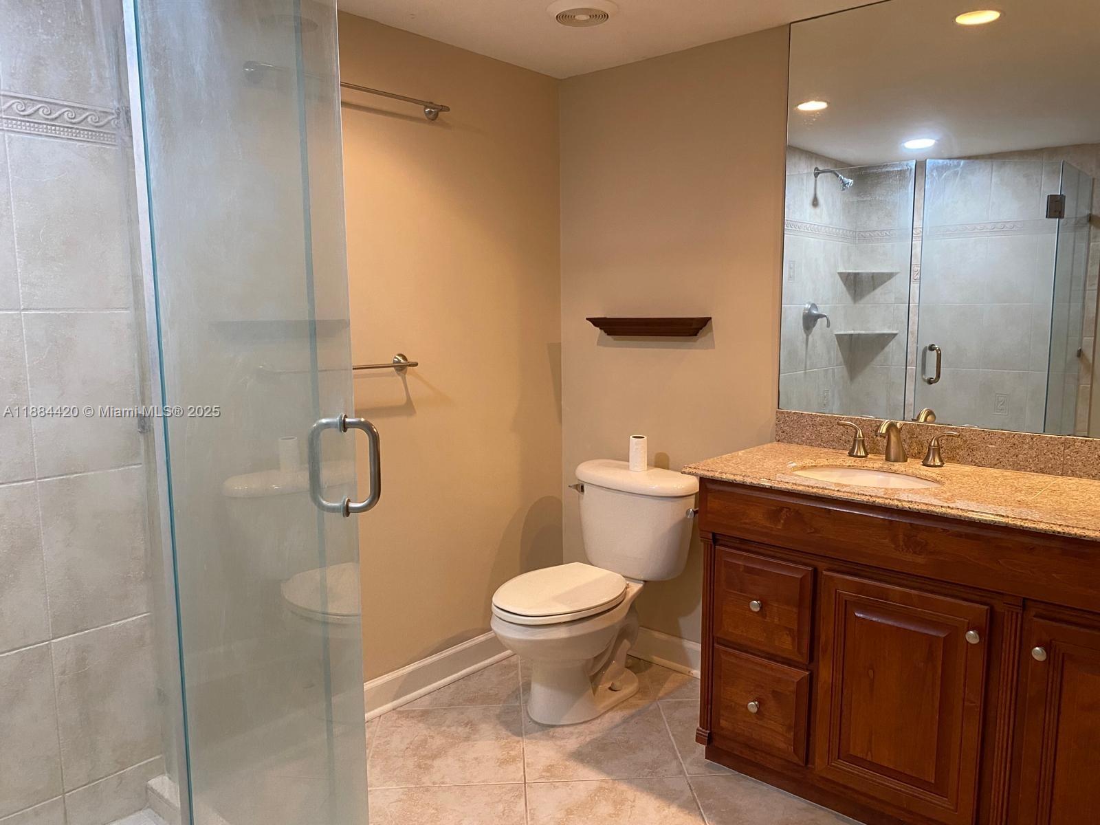 4200 North Ocean Drive, Unit 11103 Riviera Beach, FL 33404 - Photo 7 of 11 a bathroom with a granite countertop sink toilet and shower