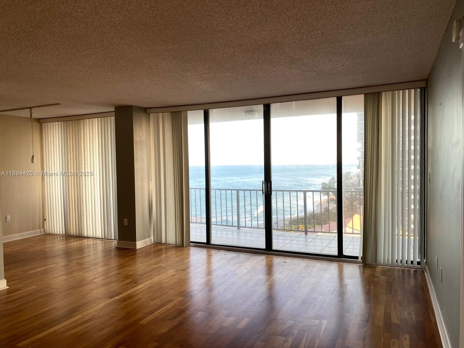 4200 North Ocean Drive, Unit 11103 Riviera Beach, FL 33404 - Photo 10 of 11 wooden floor in an empty room with a window