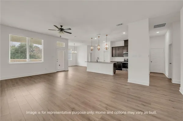 a view of kitchen with furniture and wooden floor