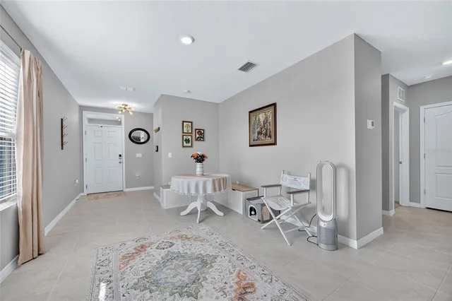 a living room with furniture a clock and a window