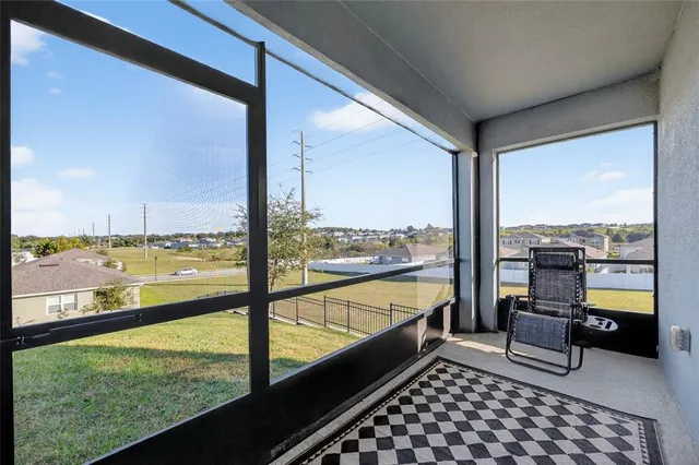 a room with water view and large windows