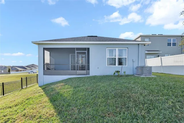 a view of a house with a backyard