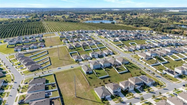 an aerial view of a house with a lake view