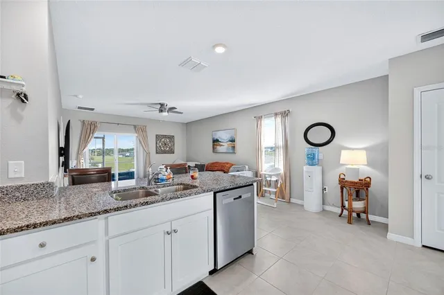 a kitchen with granite countertop a sink and a cabinets