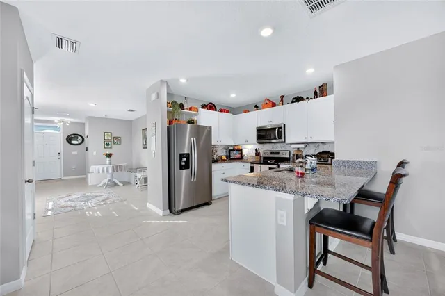 a view of kitchen with refrigerator and furniture