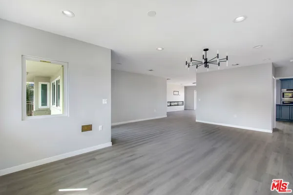 a view of a room with wooden floor
