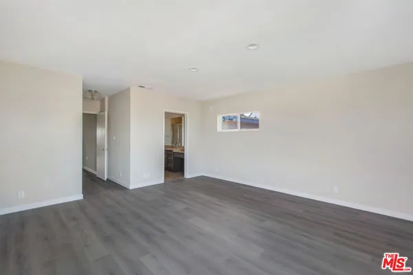 a view of a kitchen with wooden floor and windows