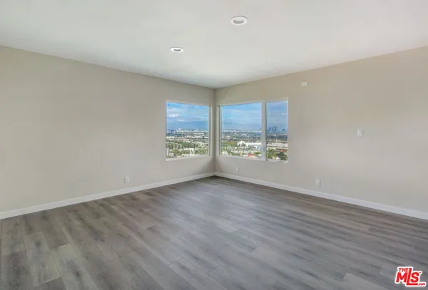 a bedroom with a bed and a television
