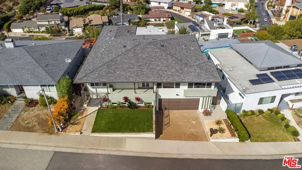 a kitchen with kitchen island granite countertop a sink cabinets and stainless steel appliances