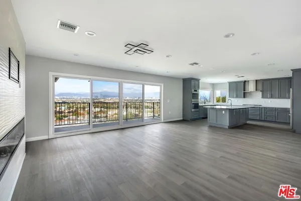 a view of a room with wooden floor