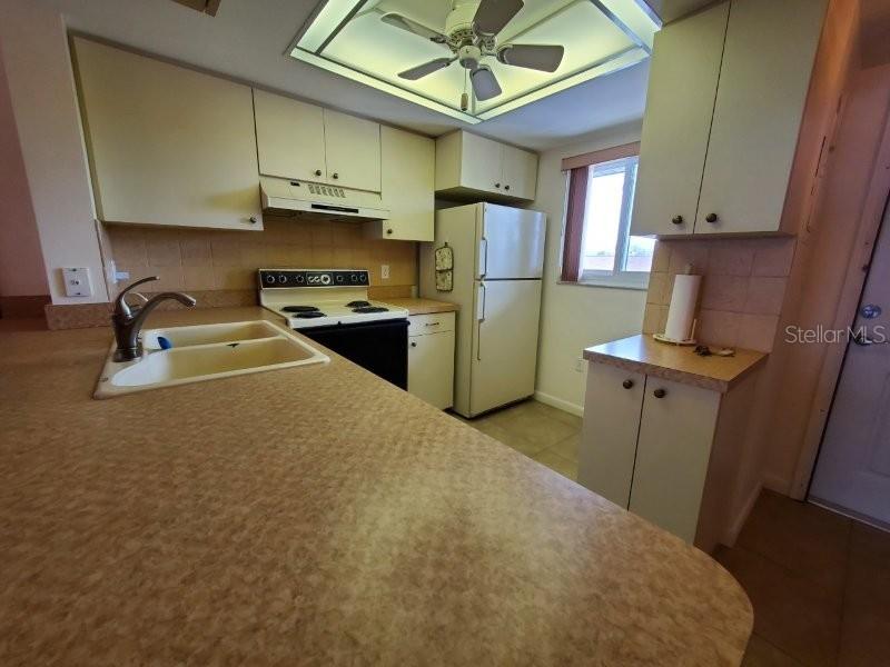 25275 Rampart Boulevard, Unit 1605 Punta Gorda, FL 33983 - Photo 14 of 16 a kitchen with a refrigerator a stove top oven a sink and dishwasher