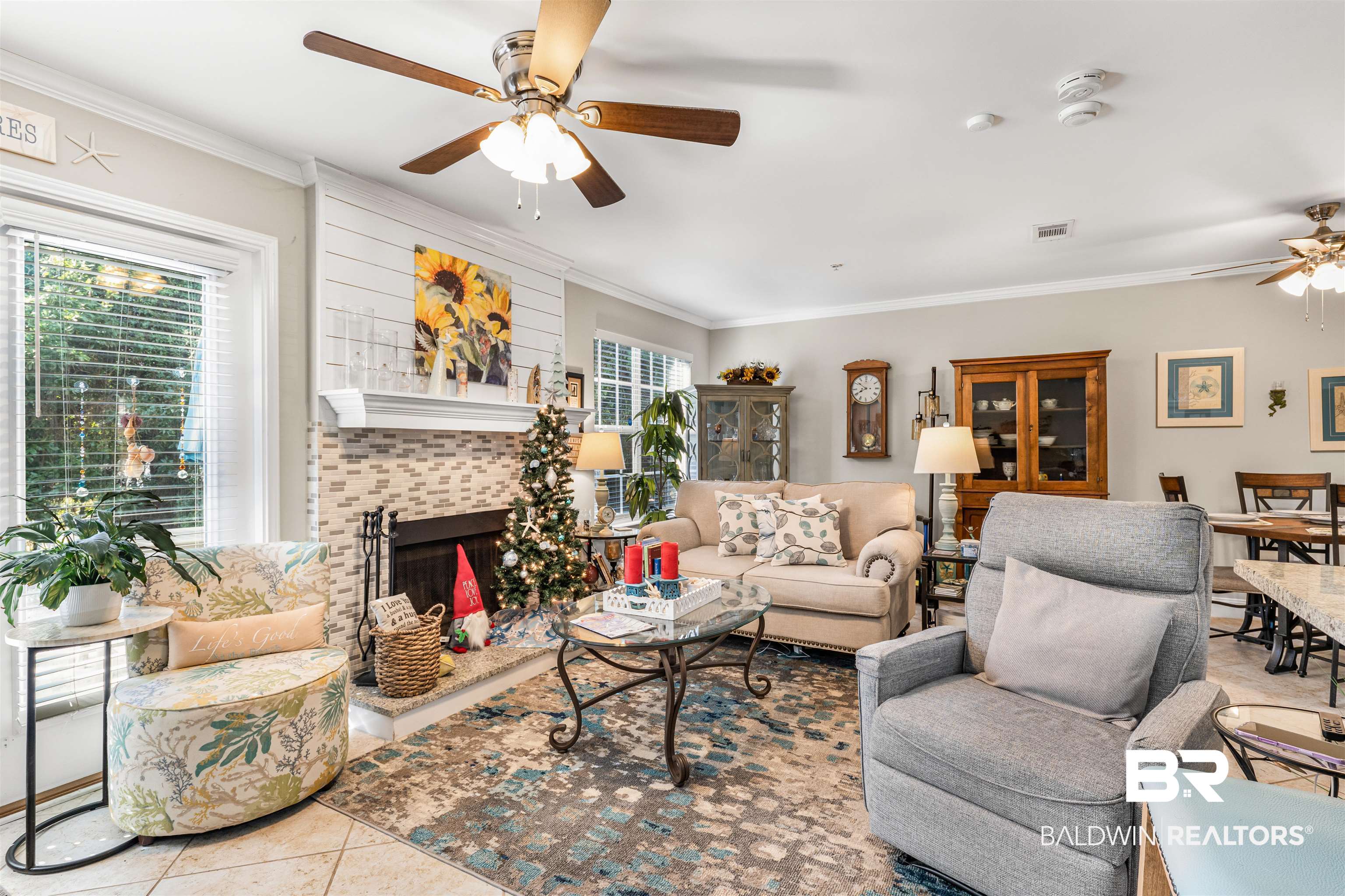 1517 Regency Road, Unit 68 Gulf Shores, AL 36542 - Photo 9 of 43 Tiled living room featuring ceiling fan, a fireplace, and ornamental molding
