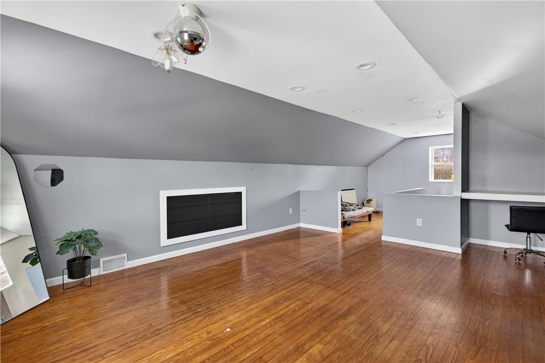 23 Harrison Street Emmaus, PA 18049 - Photo 20 of 28 A versatile open-concept space featuring hardwood flooring and sloped ceilings.