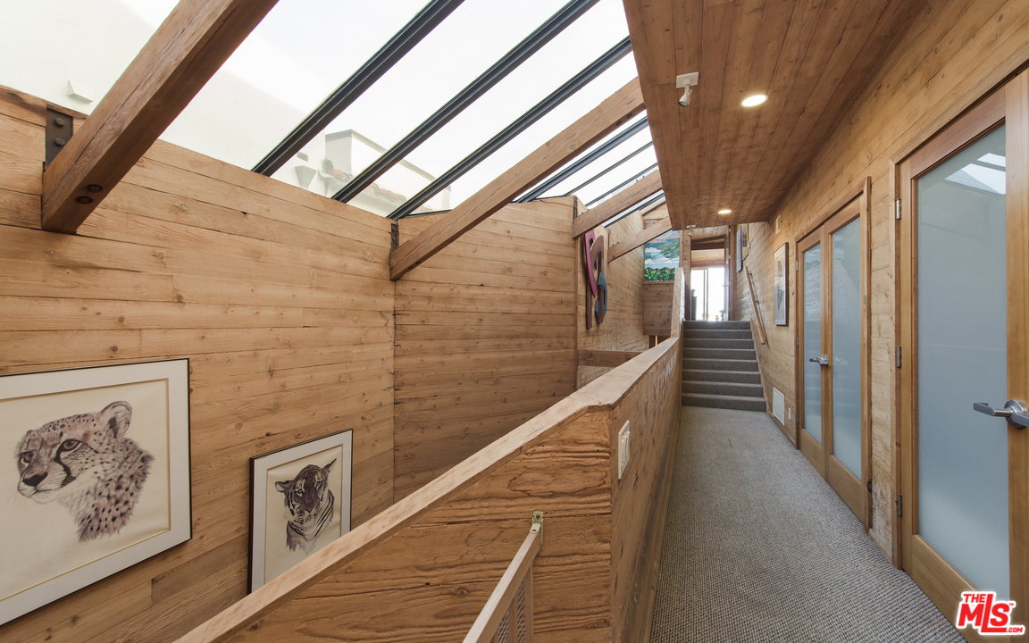 23768 Malibu Road Malibu, CA 90265 - Photo 13 of 23 a view of a hallway with wooden floor and staircase