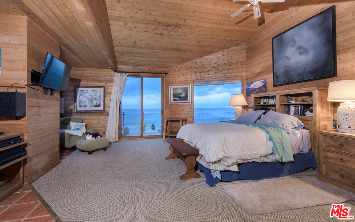 23768 Malibu Road Malibu, CA 90265 - Photo 14 of 23 a bed room with a bed and furniture