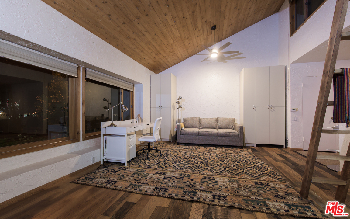 23768 Malibu Road Malibu, CA 90265 - Photo 19 of 23 a living room with furniture and a rug